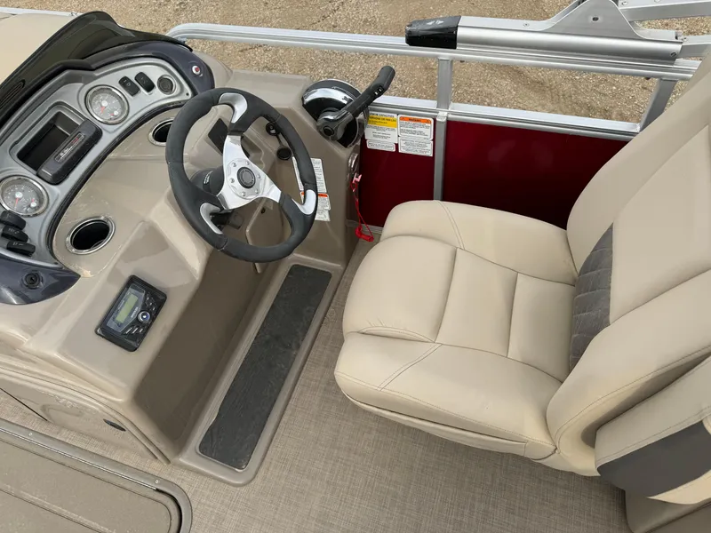 Slide: The Image of 2022 Sun Tracker Party Barge 22 XP3 helm with beige seating and control panel. - 14