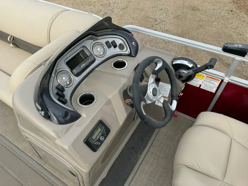 Slide: The Image of 2022 Sun Tracker Party Barge 22 XP3 helm with steering wheel and control panel. - 16