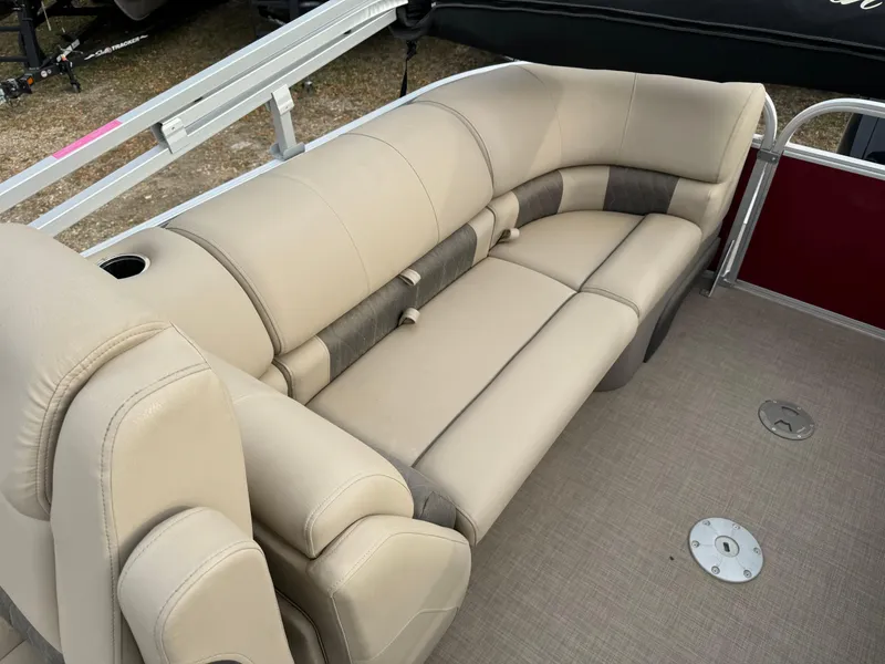 Slide: The Image of 2022 Sun Tracker Party Barge 22 XP3 interior with beige seating and cup holders. - 18