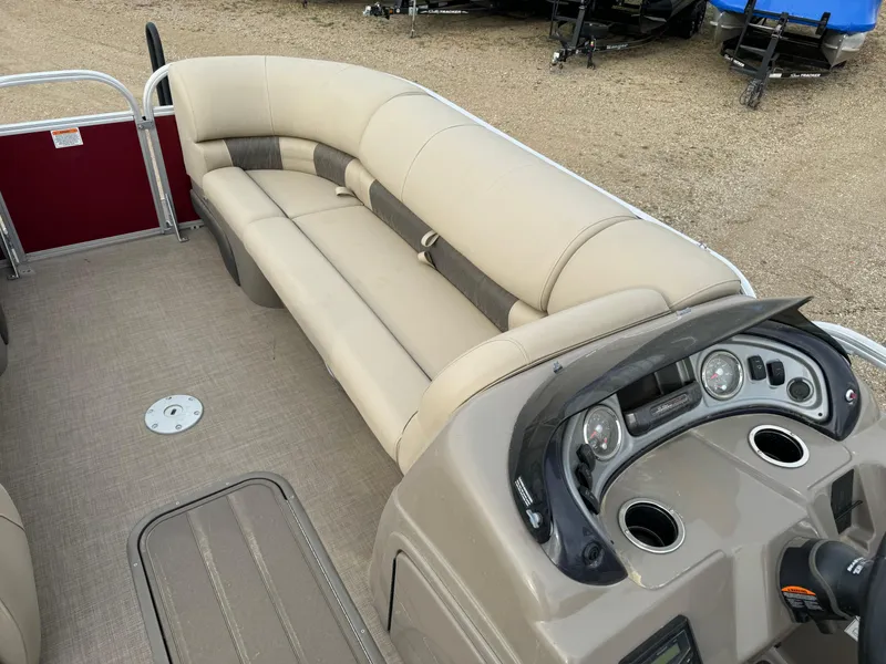 Slide: The Image of 2022 Sun Tracker Party Barge 22 XP3 interior with beige seating and control panel. - 19