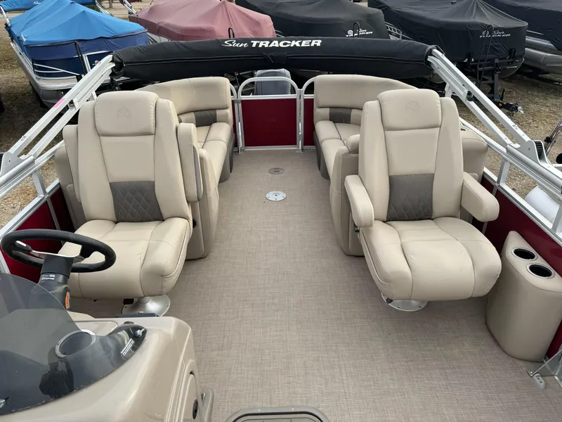 Slide: The Image of 2022 Sun Tracker Party Barge 22 XP3 with beige seating and steering wheel. - 9