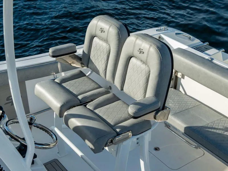 Slide: The Image of 2025 Sea Pro 242 DLX boat seats with quilted design, on calm water. - 11