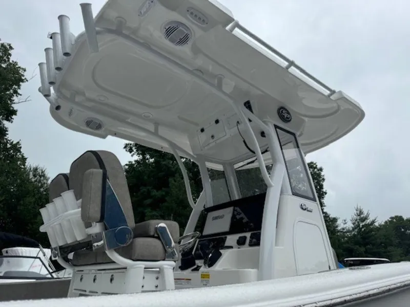 Slide: The Image of 2025 Sea Pro 242 DLX boat with T-top and dual seating, viewed from the side. - 6