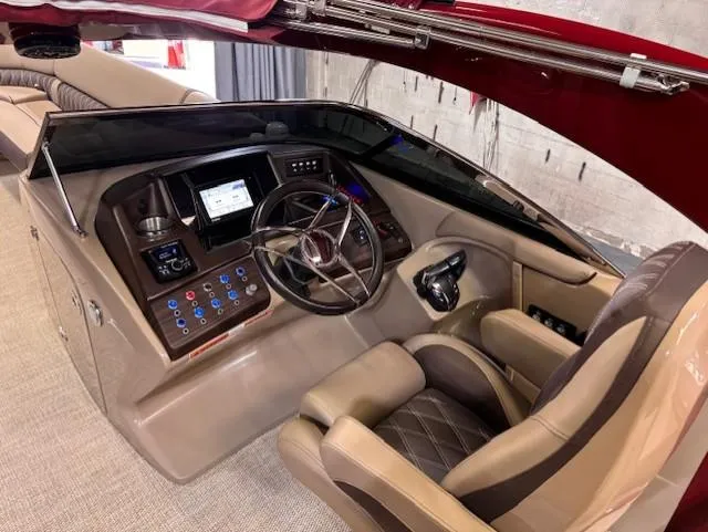 Slide: The Image of 2021 Bennington QX 30 boat helm with modern controls and luxurious seating. - 12