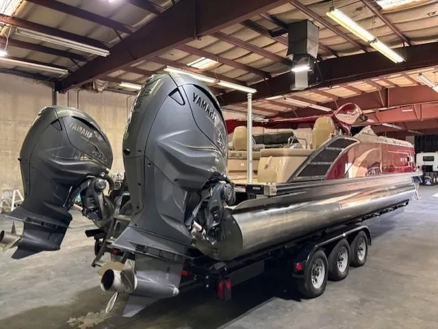 Slide: The Image of 2021 Bennington QX 30 pontoon boat with Yamaha engines in a warehouse. - 4