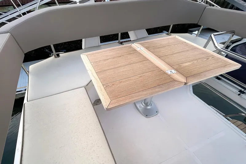 Slide: The Image of Flybridge seating area with wooden table on 2024 Sessa Marine F42 yacht. - 13