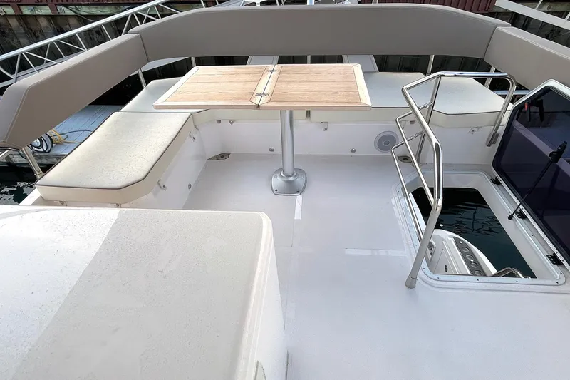Slide: The Image of 2024 Sessa Marine F42 Flybridge with seating and table on deck. - 14