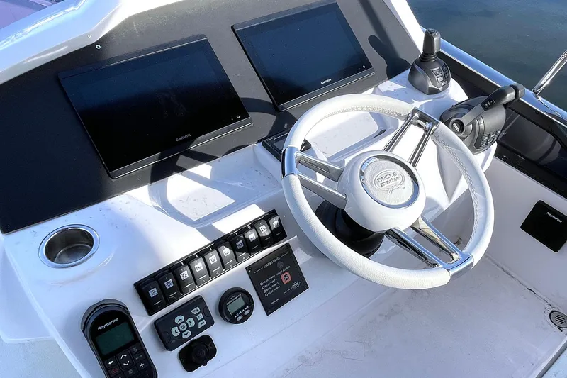 Slide: The Image of 2024 Sessa Marine F42 Flybridge helm with dual screens and modern controls. - 15