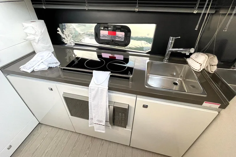 Slide: The Image of Modern kitchen in 2024 Sessa Marine F42 Flybridge yacht with stove and sink. - 7