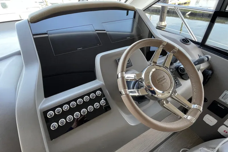 Slide: The Image of 2024 Sessa Marine F42 Flybridge helm with modern steering wheel and control panel. - 9