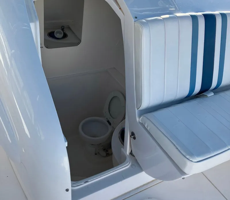 Slide: The Image of 2016 Intrepid 400 Center Console boat interior with seating and toilet. - 13