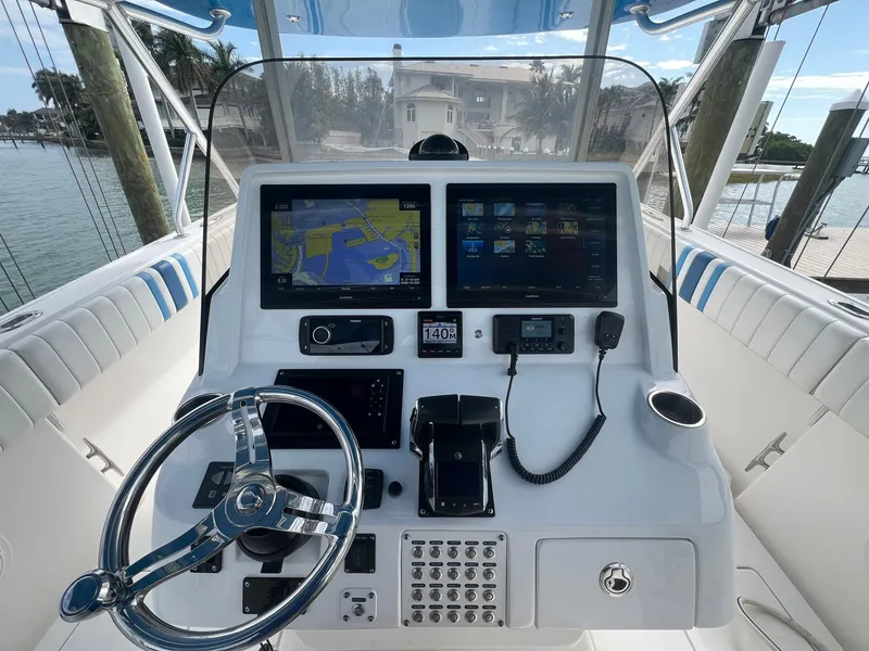 Slide: The Image of 2016 Intrepid 400 Center Console helm with navigation screens and controls. - 19