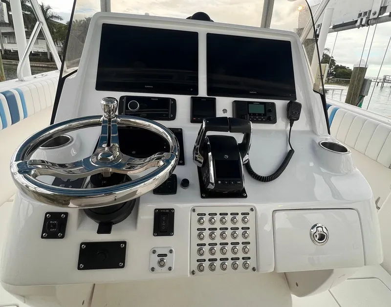Slide: The Image of 2016 Intrepid 400 Center Console boat dashboard with dual screens and controls. - 23