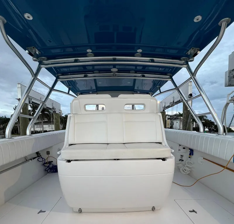 Slide: The Image of 2016 Intrepid 400 Center Console boat interior with white seating and blue canopy. - 33