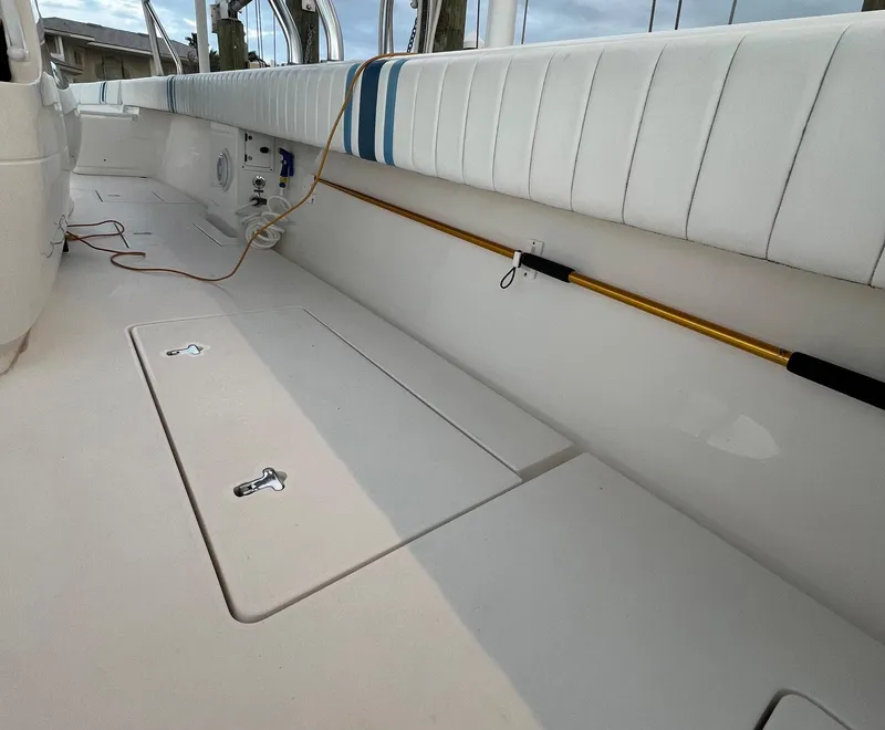Slide: The Image of 2016 Intrepid 400 Center Console boat interior with cushioned seating and storage compartments. - 35