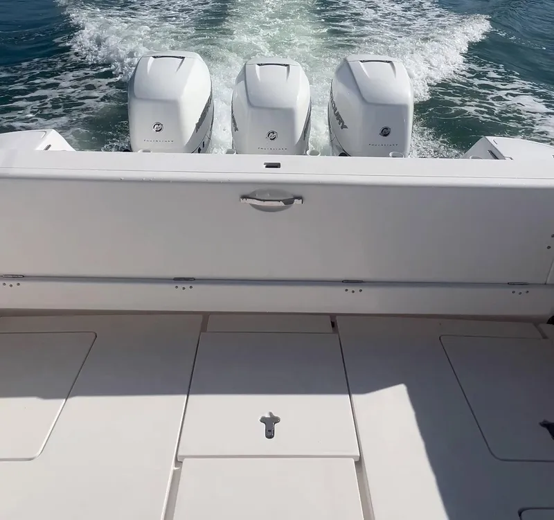 Slide: The Image of 2016 Intrepid 400 Center Console with triple outboard engines on the water. - 40