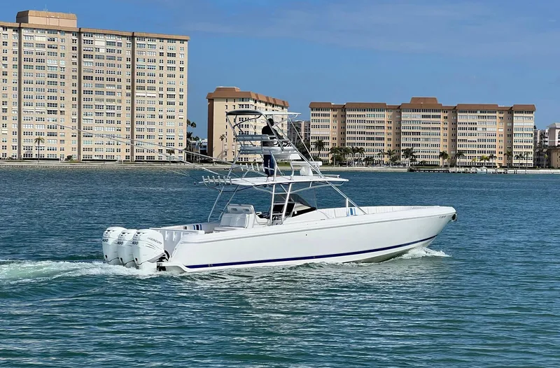 Slide: The Image of 2016 Intrepid 400 Center Console boat cruising near waterfront buildings. - 45