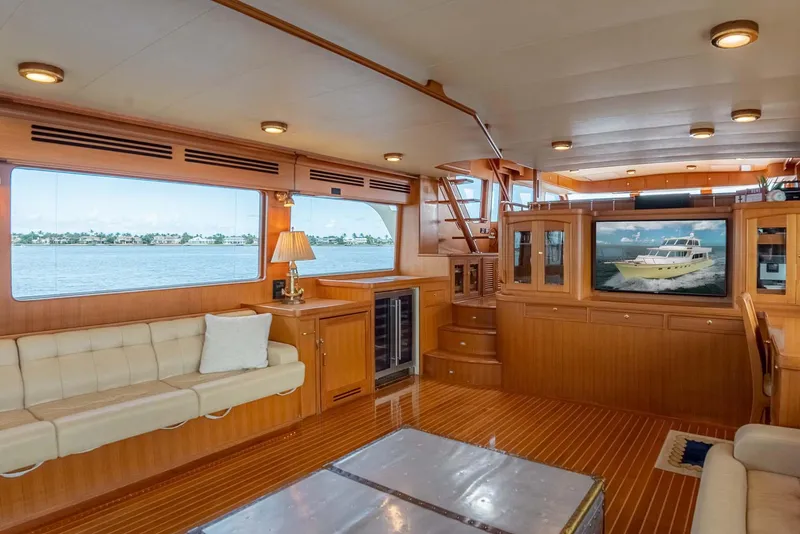 Slide: The Image of Luxurious interior of 2006 Marlow 72E LRC yacht with elegant wood flooring and plush seating. - 10