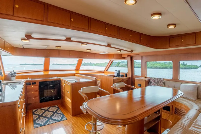 Slide: The Image of Luxurious interior of 2006 Marlow 72E LRC yacht with elegant seating and wooden flooring. - 12