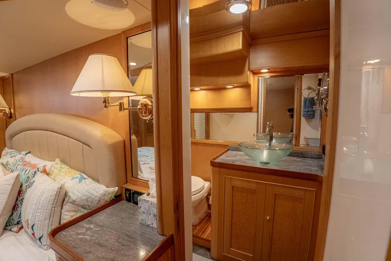 Slide: The Image of Luxurious bedroom interior of 2006 Marlow 72E LRC yacht with elegant wood finishes. - 24