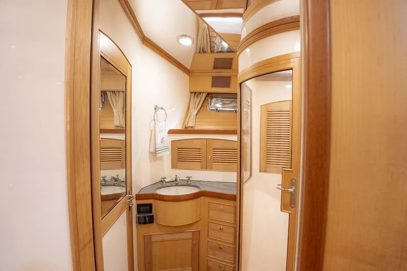 Slide: The Image of Luxurious wooden interior of 2006 Marlow 72E LRC yacht cabin with ample storage. - 26
