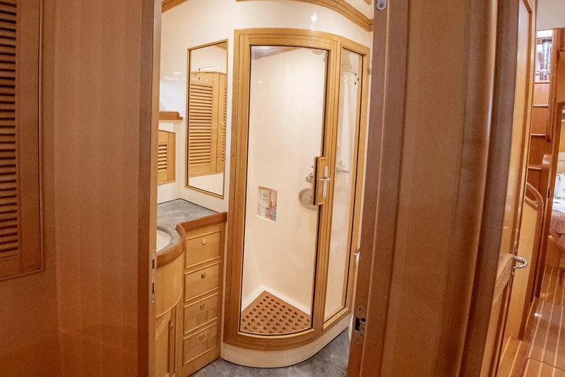 Slide: The Image of Luxurious cabin interior of 2006 Marlow 72E LRC yacht with wooden cabinetry and cozy bedding. - 27
