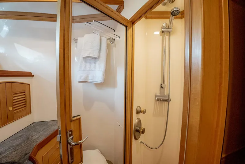 Slide: The Image of Luxurious bathroom in 2006 Marlow 72E LRC yacht with glass sink and wooden cabinetry. - 29