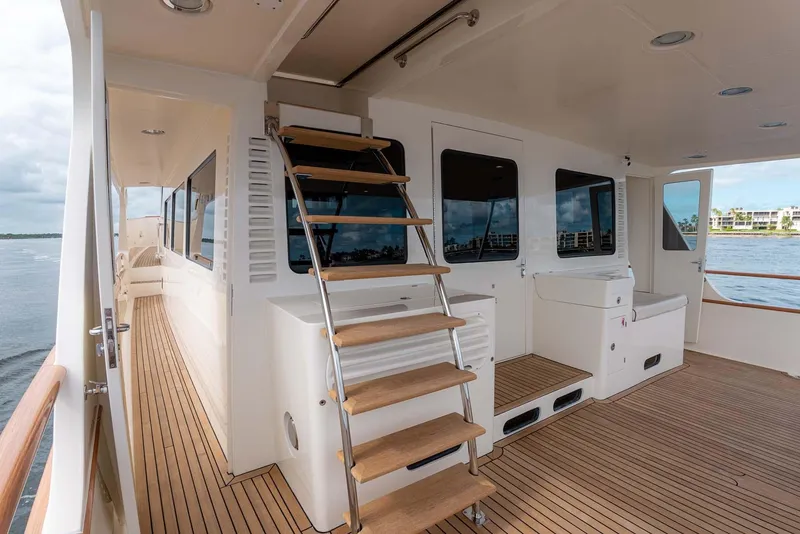 Slide: The Image of Luxurious 2006 Marlow 72E LRC yacht deck with stylish seating and nautical-themed cushions. - 50