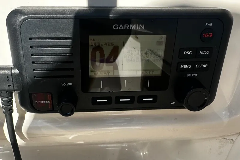 Slide: The Image of Garmin marine radio on 2018 Robalo R227 Dual Console boat dashboard. - 10