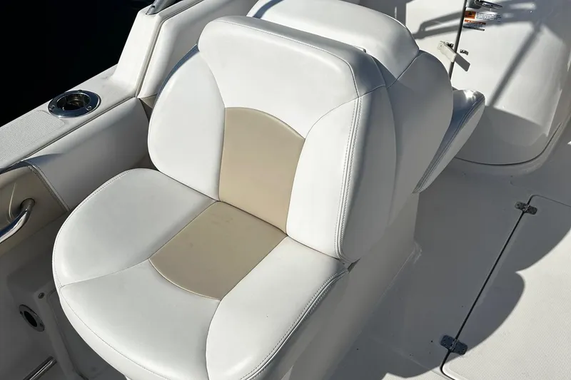 Slide: The Image of 2018 Robalo R227 Dual Console boat seat with white and beige upholstery. - 13