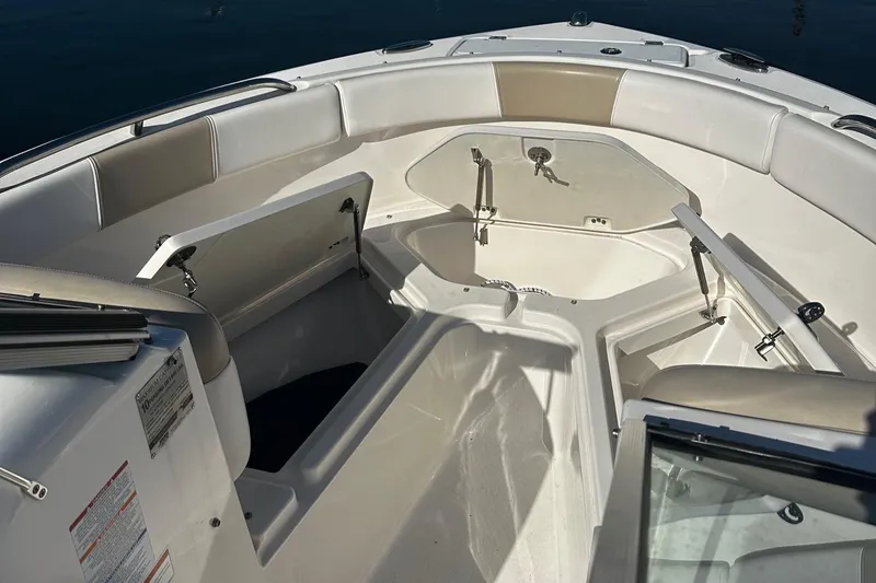 Slide: The Image of 2018 Robalo R227 Dual Console boat interior with open storage compartments. - 3