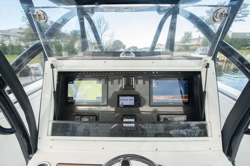 Slide: The Image of 2016 SeaHunter 35 Tournament boat dashboard with navigation screens and controls. - 16
