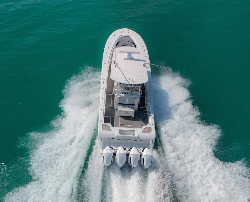 Slide: The Image of 2022 Front Runner 39 Center Console boat cruising on turquoise water. - 26