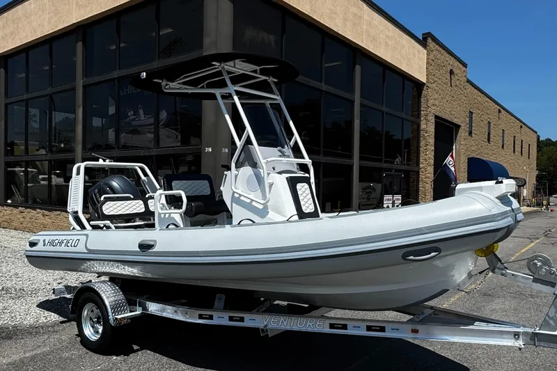 The Image of 2025 Highfield Sport 560 boat on trailer outside a building. - 0