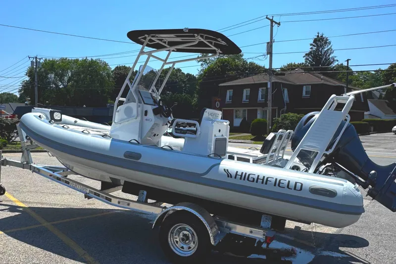 Slide: The Image of 2025 Highfield Sport 560 boat on trailer outside a building. - 3