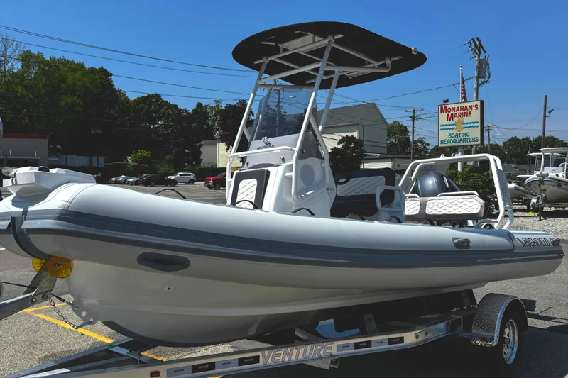 Slide: The Image of 2025 Highfield Sport 560 boat on trailer, parked outdoors under clear sky. - 4