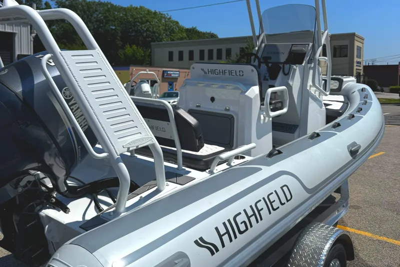 Slide: The Image of 2025 Highfield Sport 560 boat on trailer, under clear blue sky. - 6