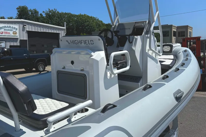 Slide: The Image of 2025 Highfield Sport 560 boat with Yamaha engine, parked outdoors on a sunny day. - 7
