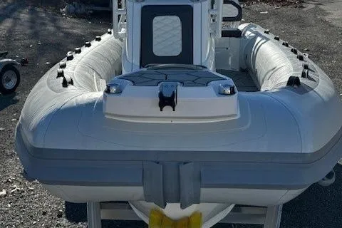 Slide: The Image of 2025 Highfield Sport 560 boat with 115 HP outboard motor, parked outdoors. - 9