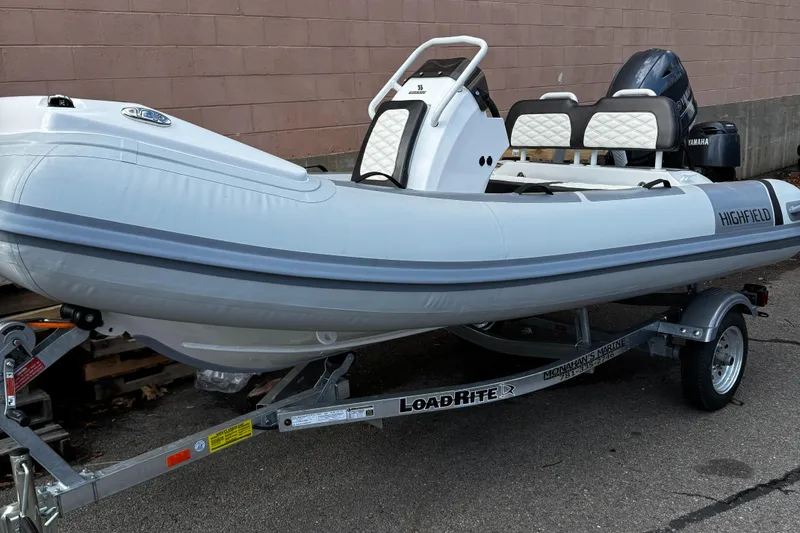 Slide: The Image of 2025 Highfield Sport 390 boat on trailer, featuring sleek design and modern seating. - 1