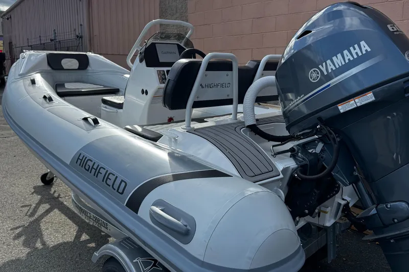 Slide: The Image of 2025 Highfield Sport 390 boat with Yamaha engine, docked outdoors. - 5