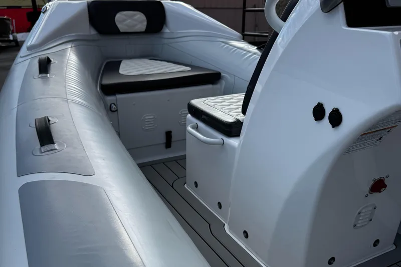Slide: The Image of 2025 Highfield Sport 390 boat interior with cushioned seating and sleek design. - 8
