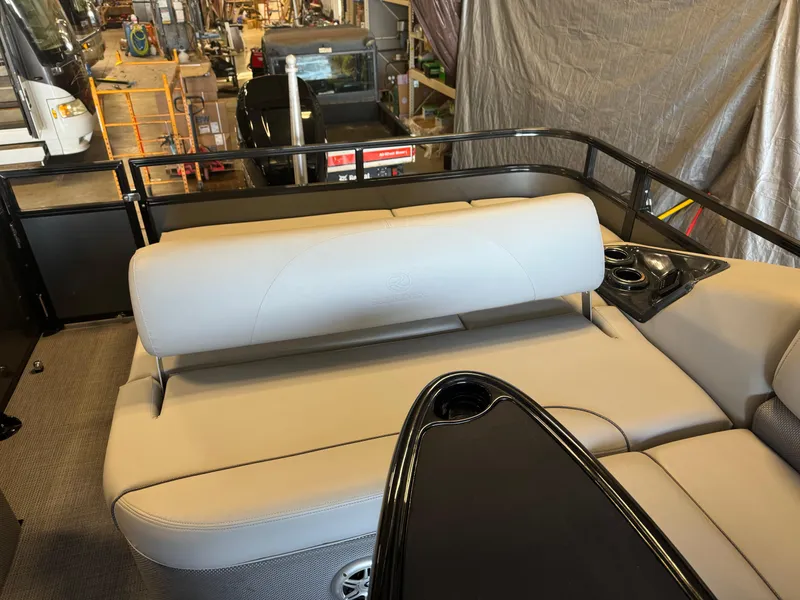 Slide: The Image of 2021 Regency 250 DL3 boat interior with beige seating and black accents. - 15