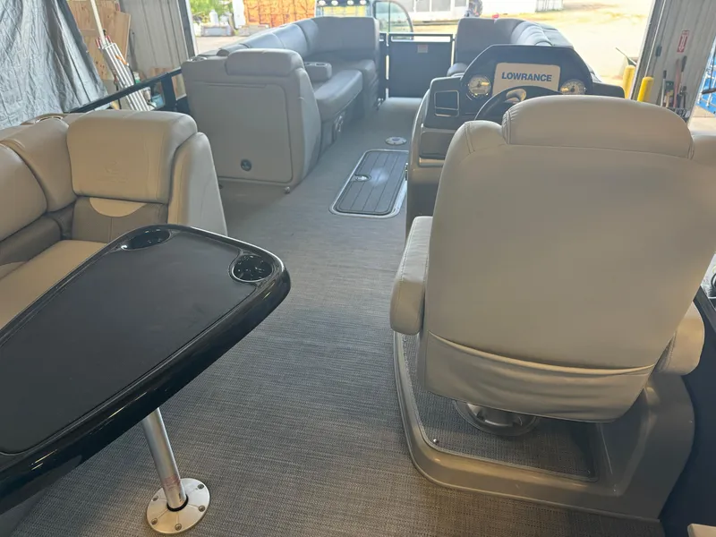 Slide: The Image of Interior of 2021 Regency 250 DL3 pontoon boat with plush seating and navigation console. - 8