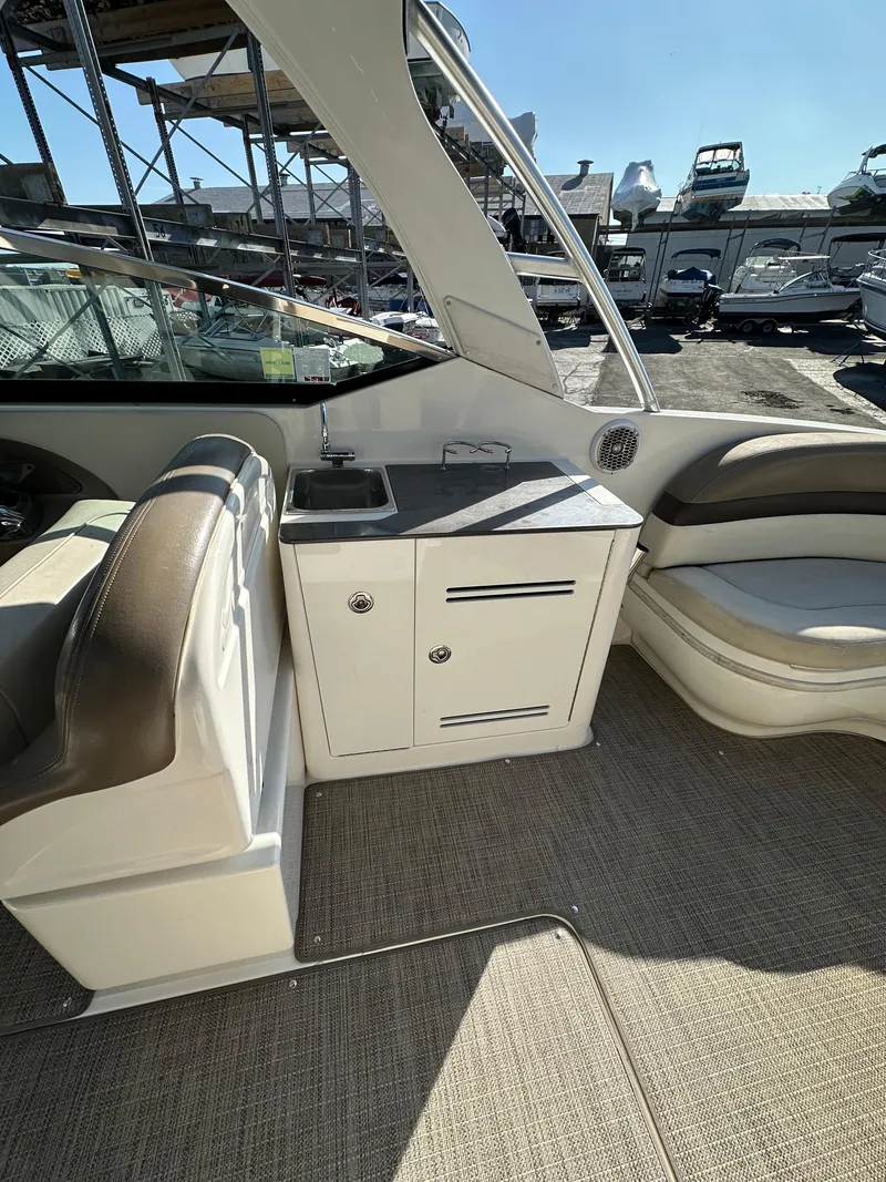 Slide: The Image of 2013 Sea Ray 300 SLX boat interior with seating and storage area. - 14