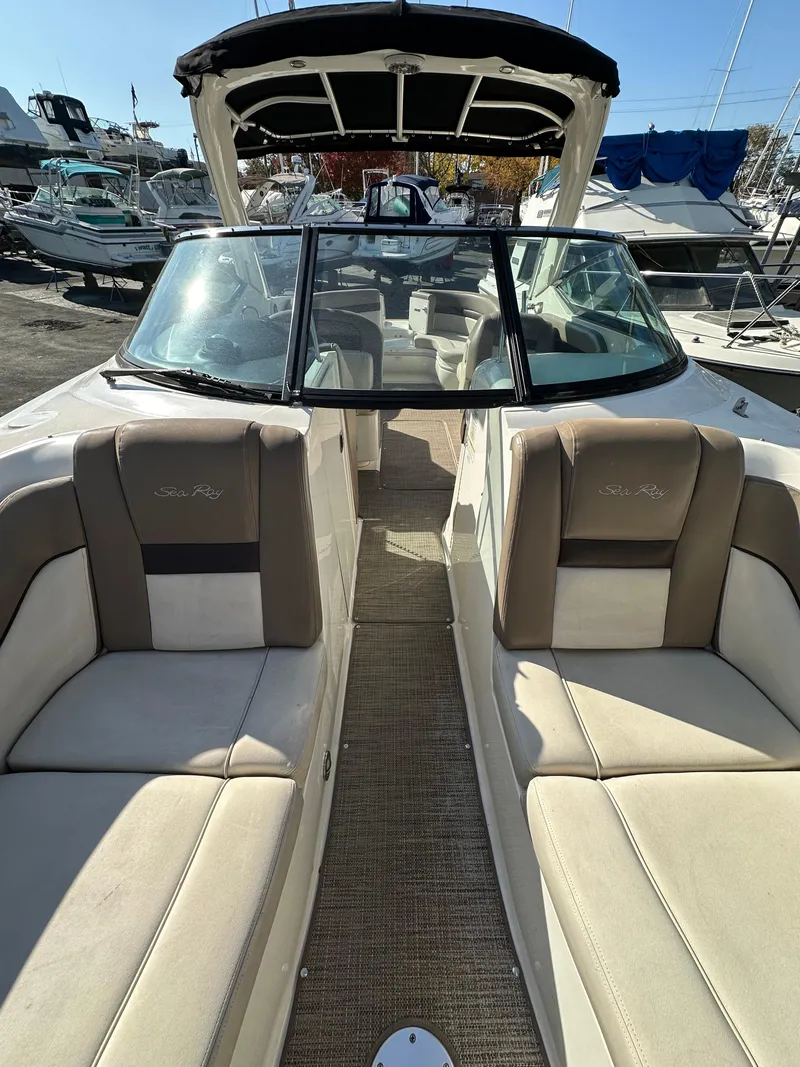 Slide: The Image of 2013 Sea Ray 300 SLX boat interior with beige seating and open deck. - 17