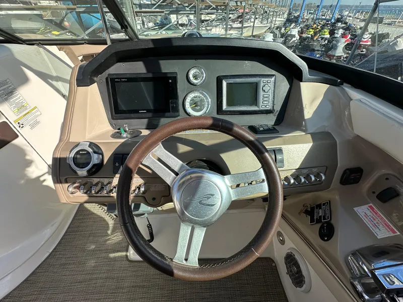 Slide: The Image of Steering wheel and dashboard of 2013 Sea Ray 300 SLX boat. - 19