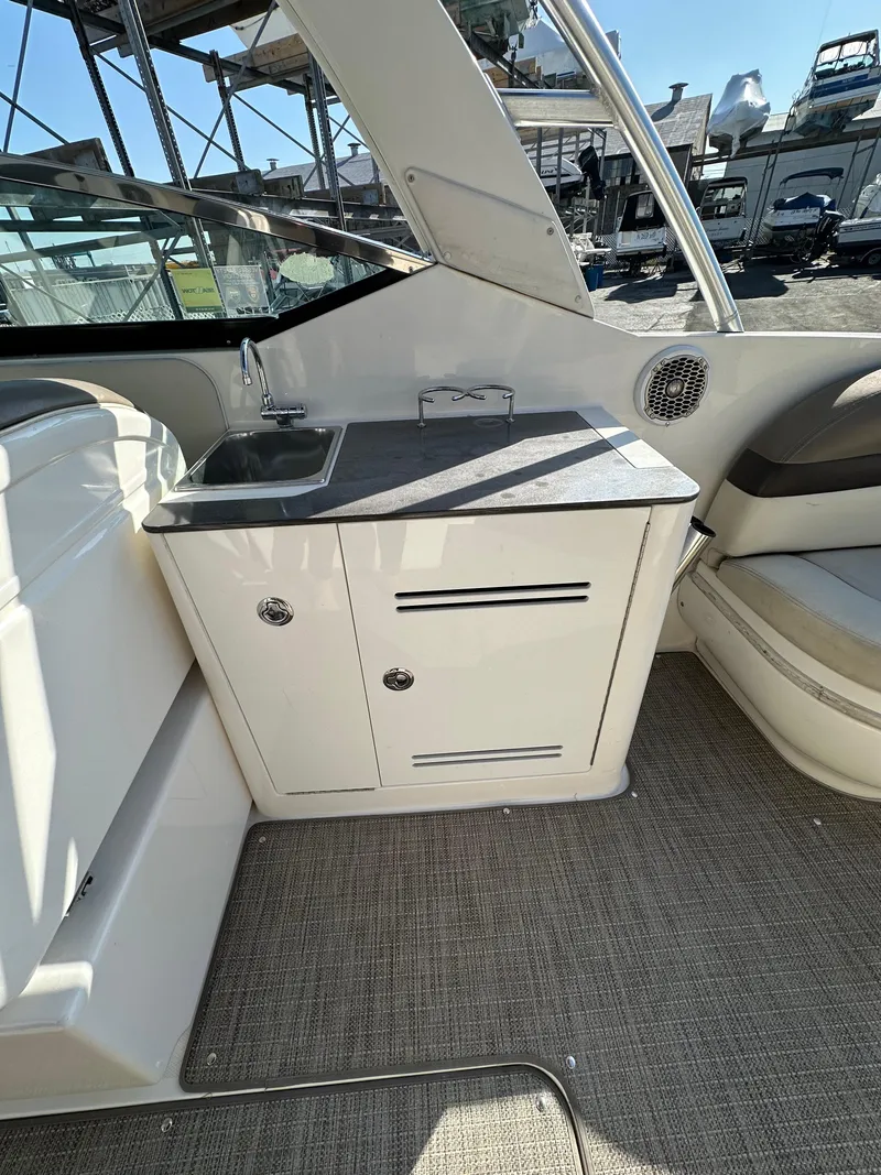 Slide: The Image of 2013 Sea Ray 300 SLX boat interior with sink and storage cabinet. - 4