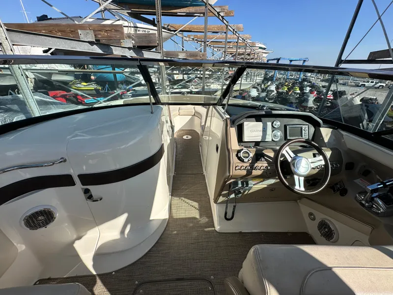 Slide: The Image of 2013 Sea Ray 300 SLX boat interior with steering wheel and dashboard controls. - 5