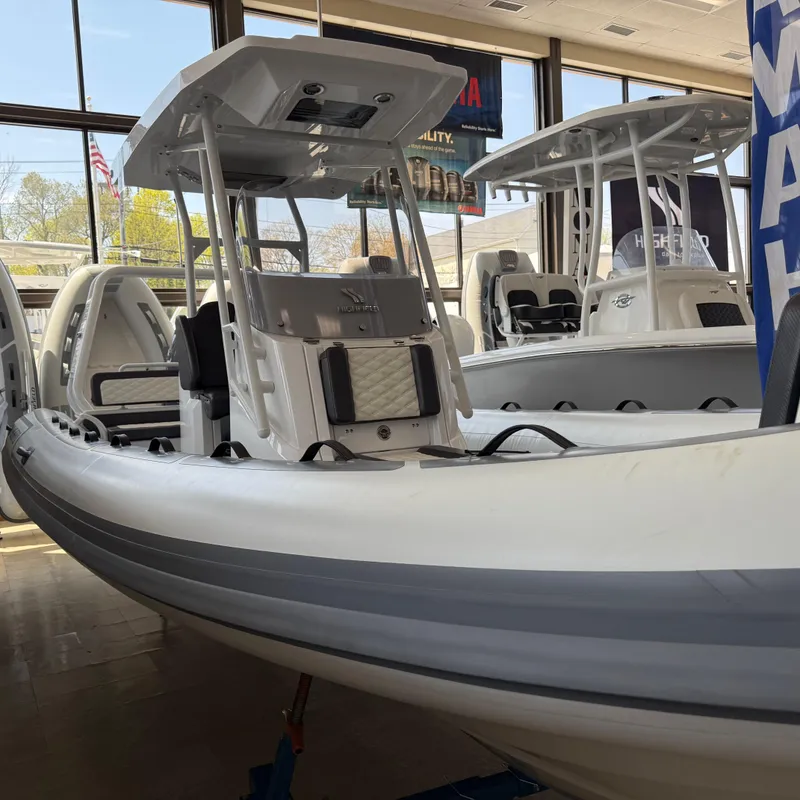 The Image of 2025 Highfield Sport 700 boat displayed in a showroom, featuring sleek design and modern amenities. - 0